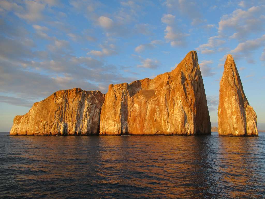 Kicker Rock’s two volcanic walls off San Cristóbal in warm light